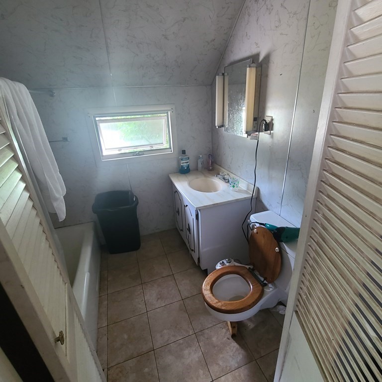 96 East Street Ware, MA 01082 - Photo 10 of 10 a bathroom with a toilet sink and mirror