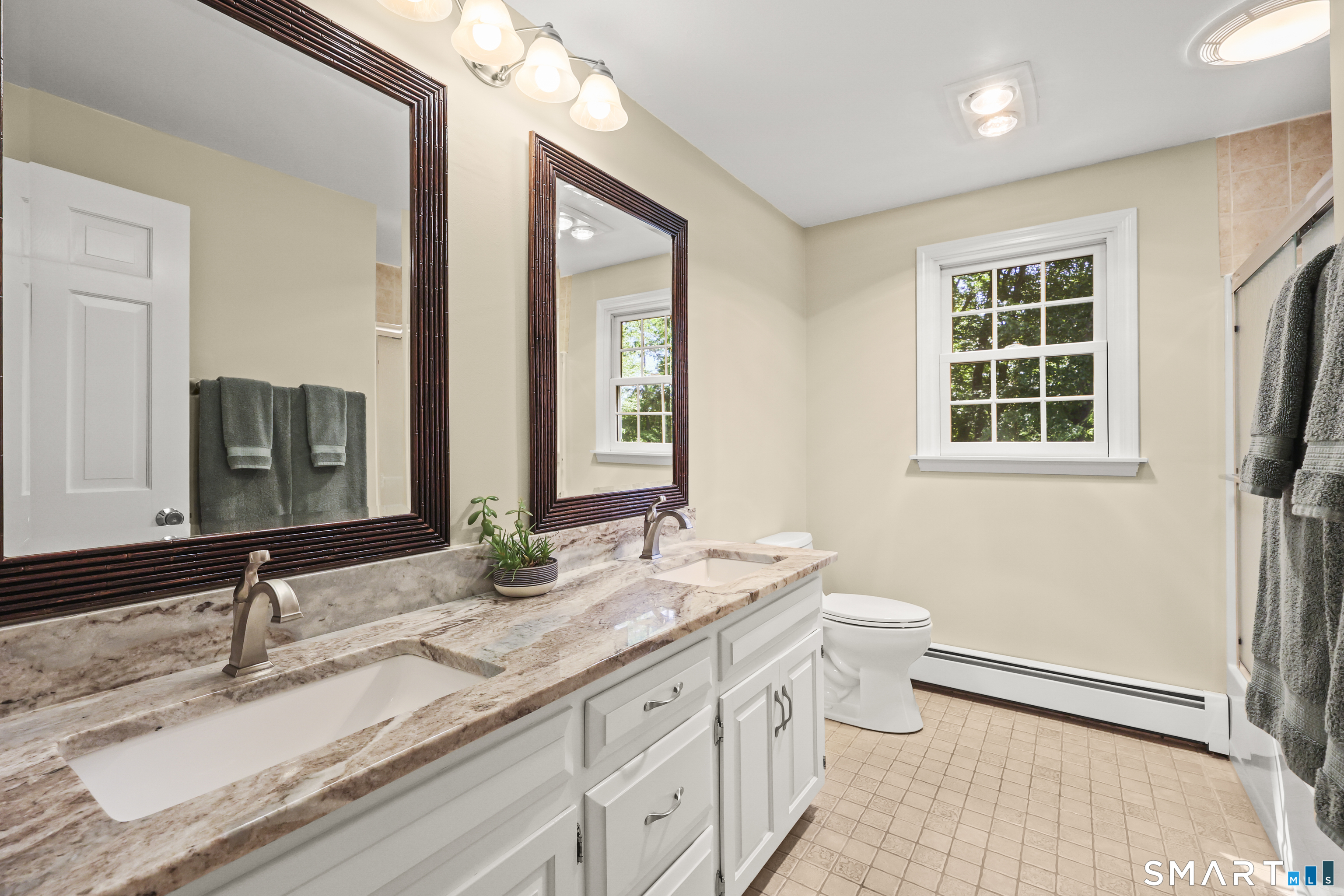 17 Briar Hill Road Avon, CT 06001 - Photo 11 of 38 Upstairs guest bathroom is warm and inviting with double sinks and granite counters.