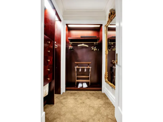 a view of a hallway with some storage and a window