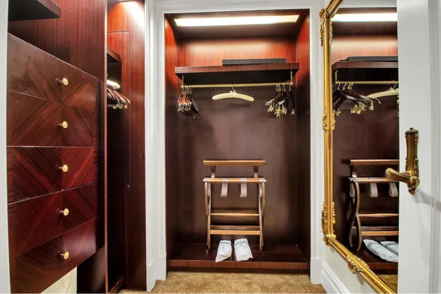 a bathroom with a walk in closet and wooden floor
