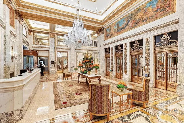 a very nice looking living room with furniture and a chandelier