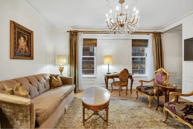 a living room with furniture a chandelier and a chandelier