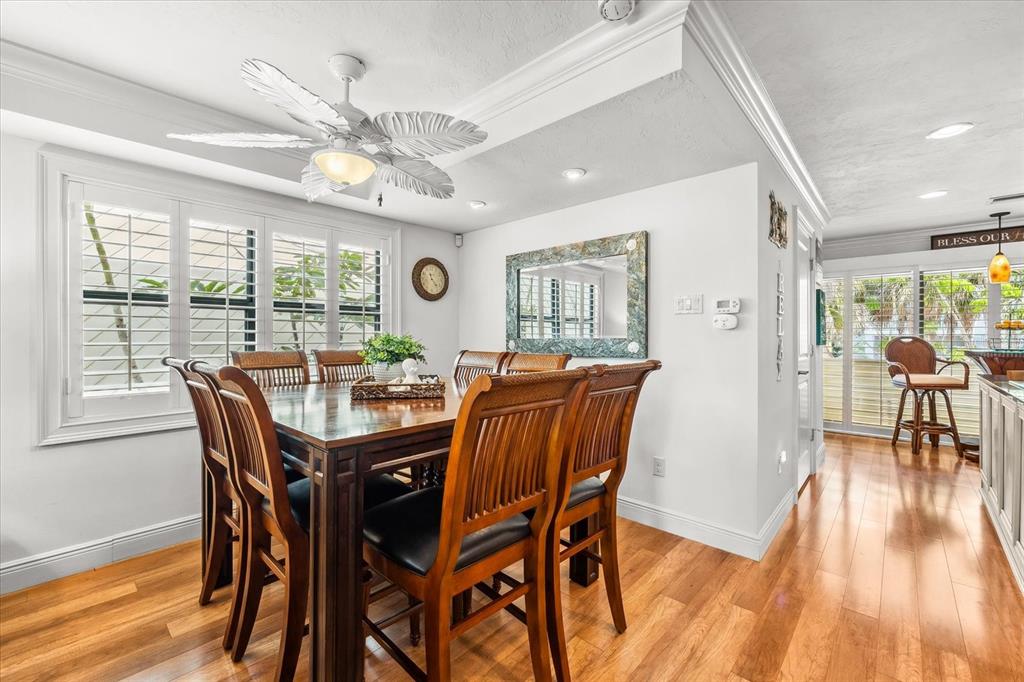 548 Beach Road, Unit 540A Sarasota, FL 34242 - Photo 11 of 77 a view of a dining room with furniture window and wooden floor
