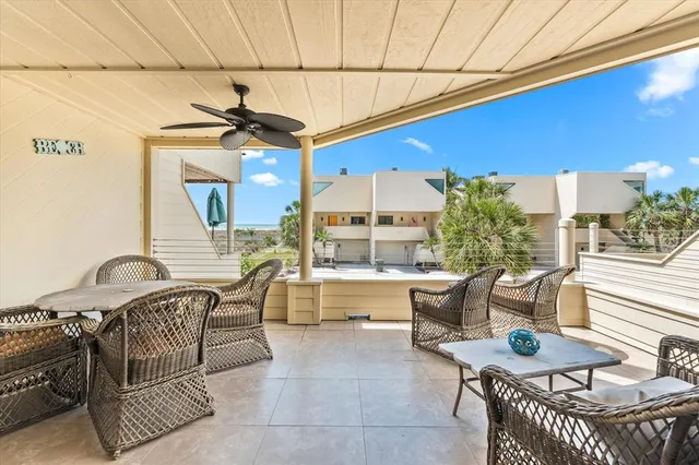 a view of a balcony with chair and glass door