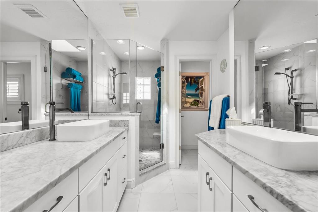 548 Beach Road, Unit 540A Sarasota, FL 34242 - Photo 25 of 77 a spacious bathroom with a granite countertop sink mirror and shower