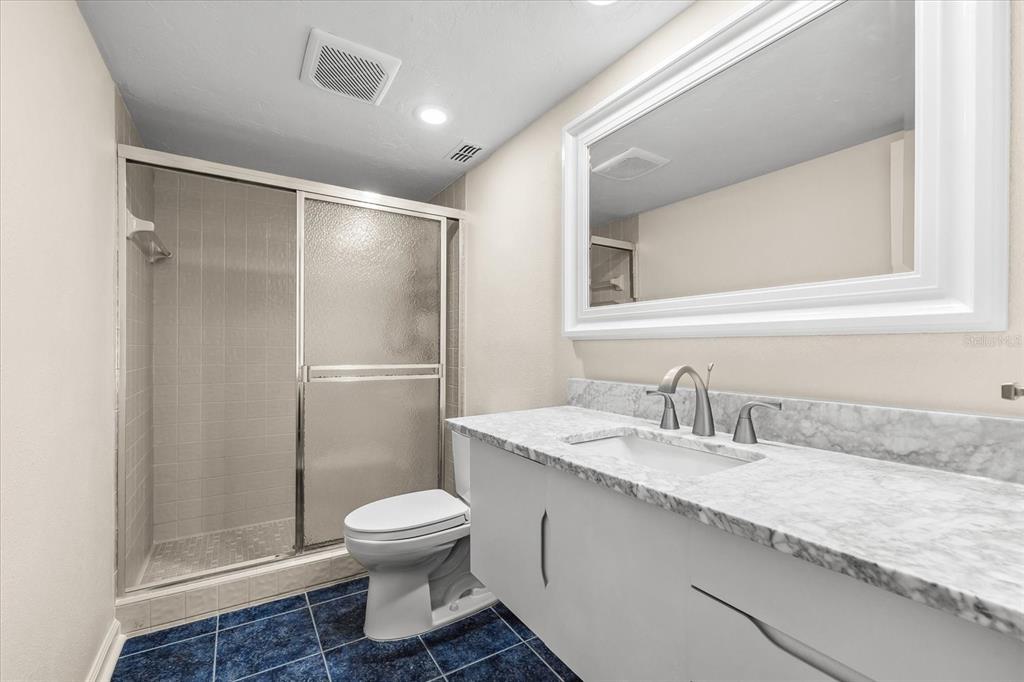 548 Beach Road, Unit 540A Sarasota, FL 34242 - Photo 35 of 77 a bathroom with a granite countertop sink toilet and shower