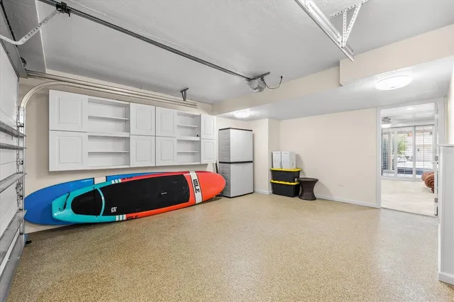 an aerial view of ocean and residential houses with outdoor space