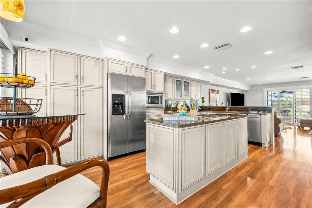 548 Beach Road, Unit 540A Sarasota, FL 34242 - Photo 6 of 77 a kitchen with stainless steel appliances granite countertop a refrigerator and a sink