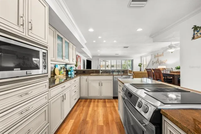 a kitchen with stainless steel appliances granite countertop a stove and a sink