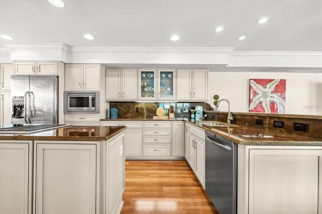 a kitchen with stainless steel appliances granite countertop a stove and a sink