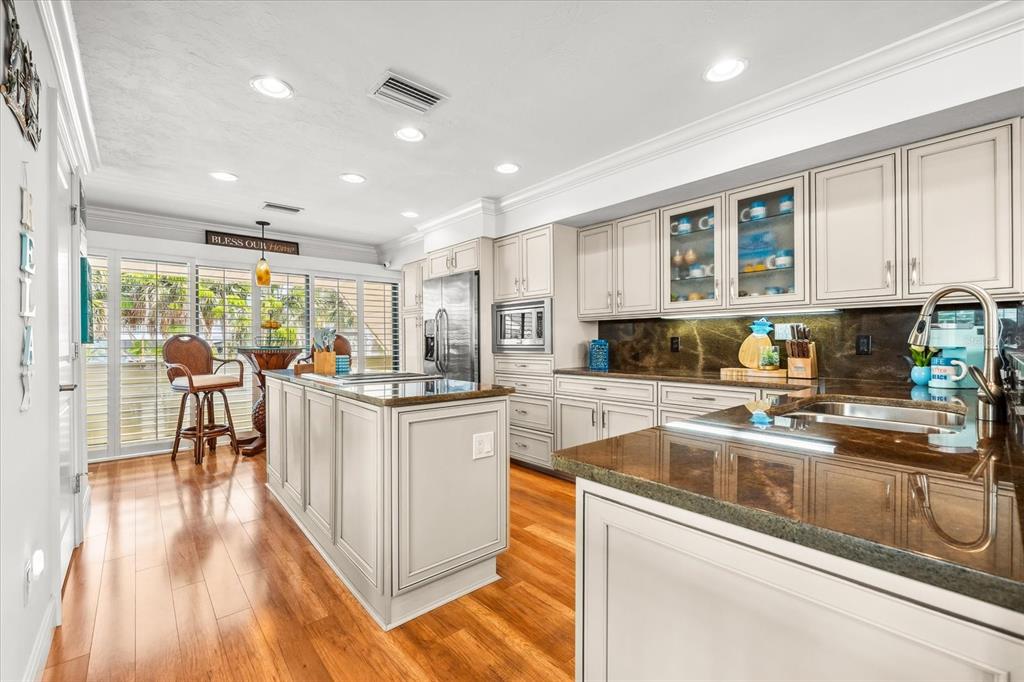 548 Beach Road, Unit 540A Sarasota, FL 34242 - Photo 9 of 77 a kitchen with stainless steel appliances granite countertop a stove and a sink