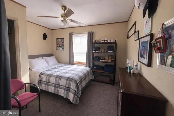 a bedroom with a bed a bookshelf and a chandelier