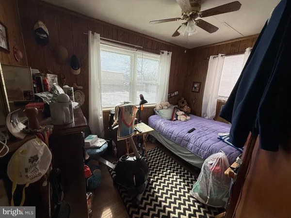 a spacious bedroom with a bed and a mirror