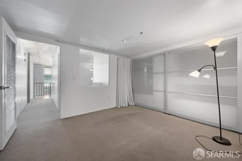 a view of an empty room with glass door