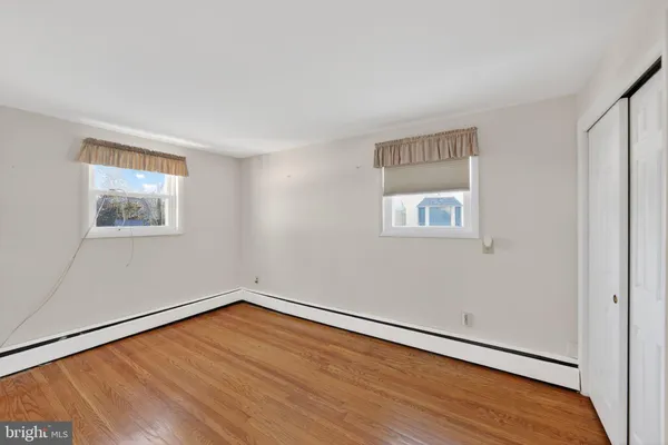 a view of a room with wooden floor and white walls
