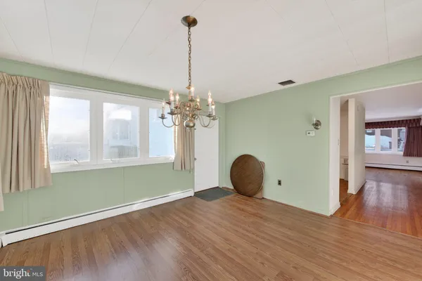 a view of a room with window wooden floor and windows