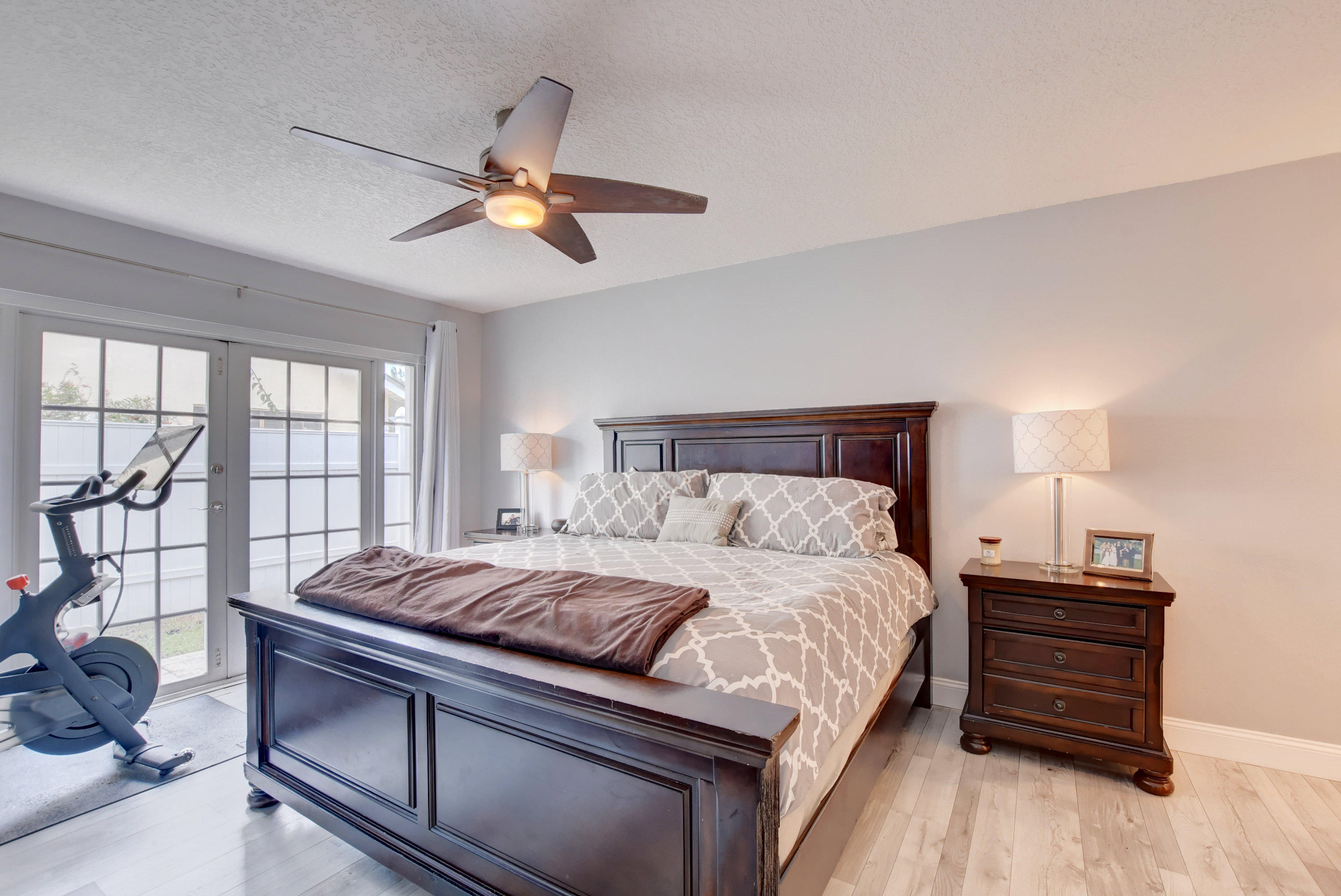 7445 Texas Trail Boca Raton, FL 33487 - Photo 21 of 28 a bedroom with a large bed and a chandelier
