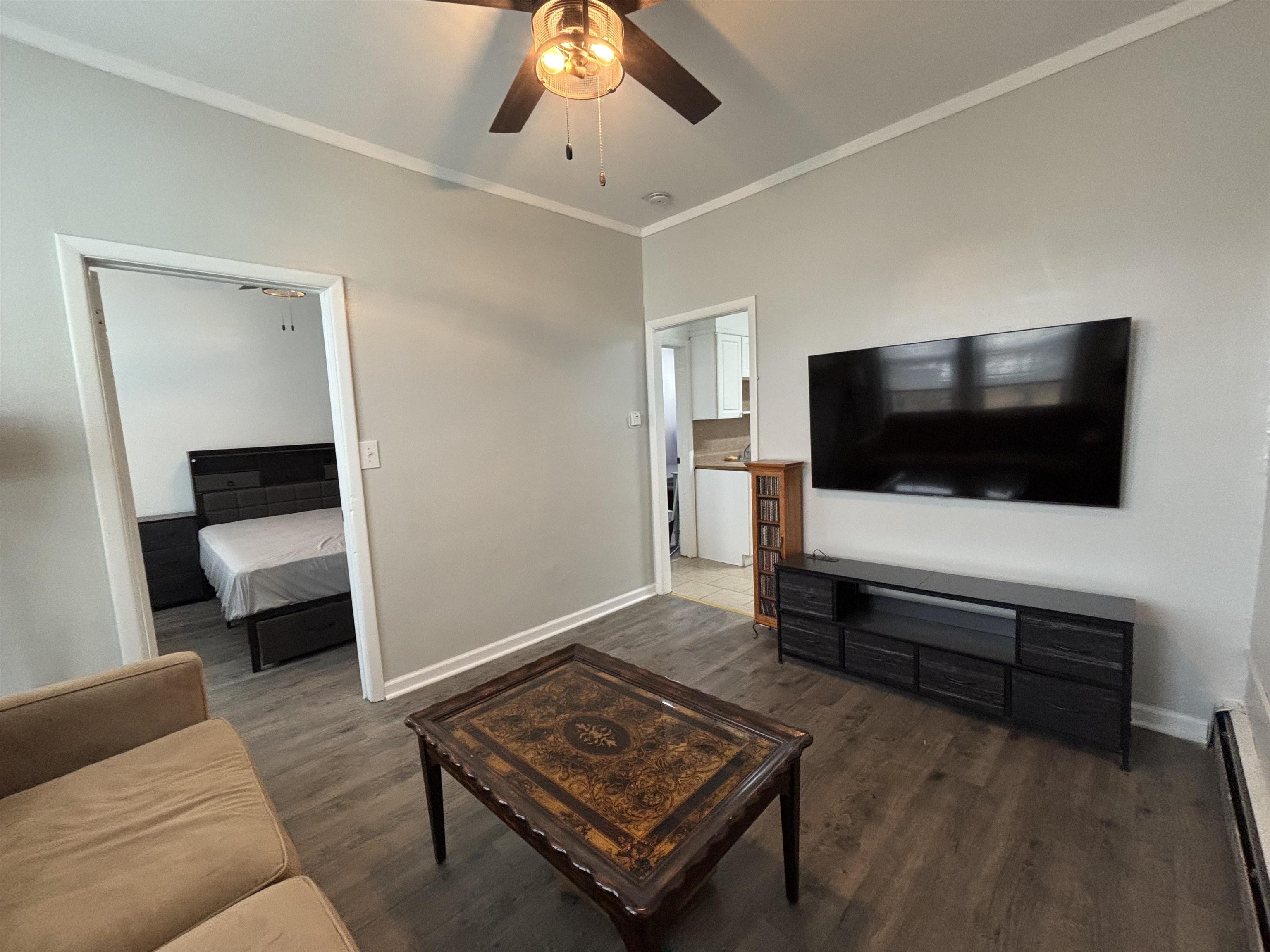 a living room with furniture and a flat screen tv