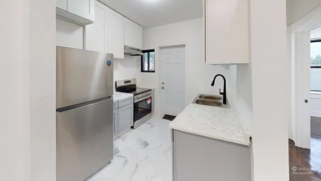 a kitchen with stainless steel appliances a refrigerator sink and cabinets