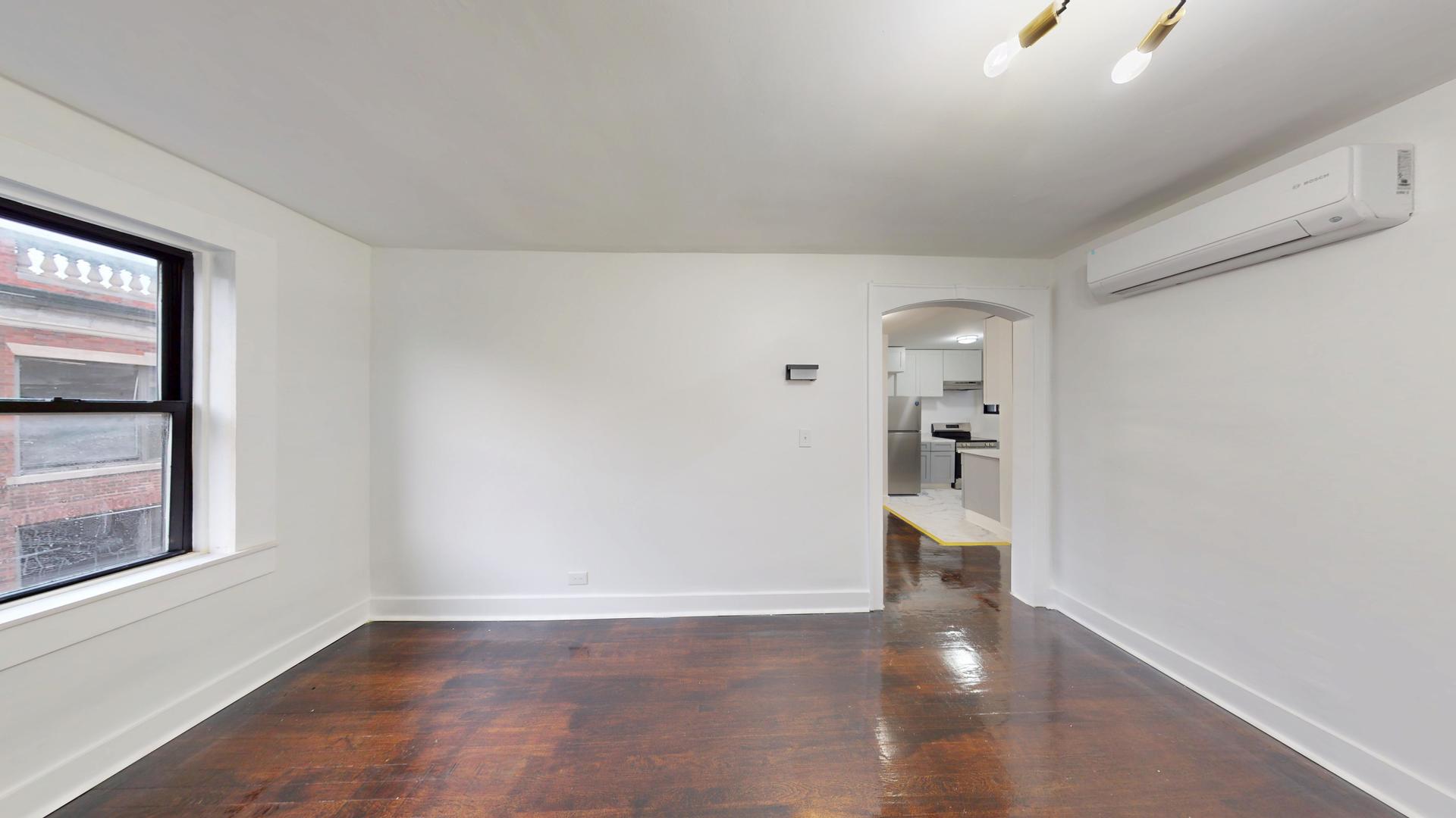 2401 East 75th Street, Unit 3 Chicago, IL 60649 - Photo 11 of 14 a view of empty room with wooden floor and windows