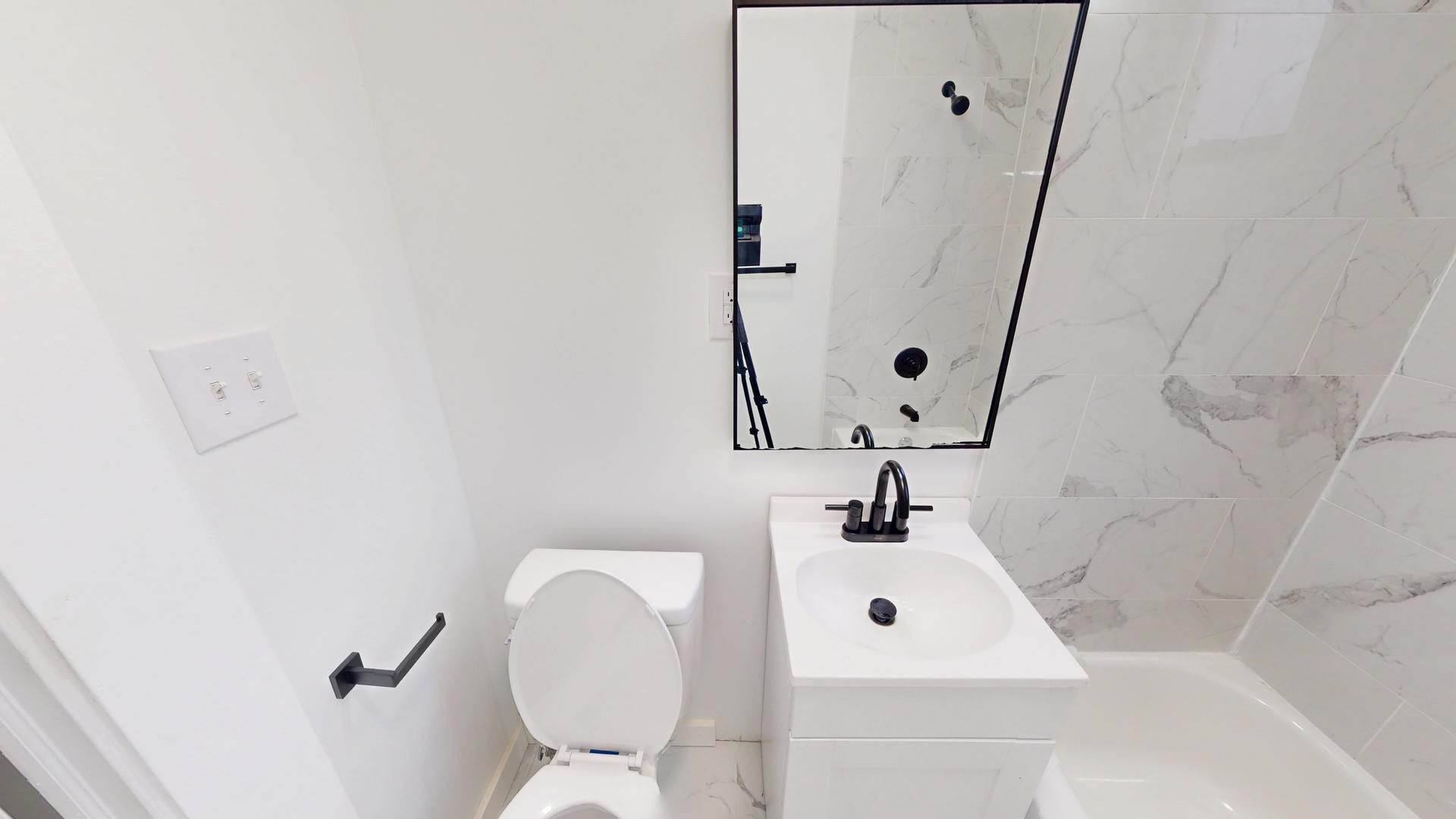 2401 East 75th Street, Unit 3 Chicago, IL 60649 - Photo 14 of 14 a bathroom with a sink mirror vanity and toilet