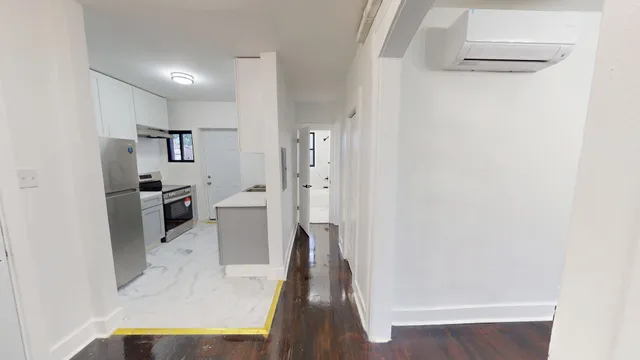 a view of a living room with furniture and wooden floor