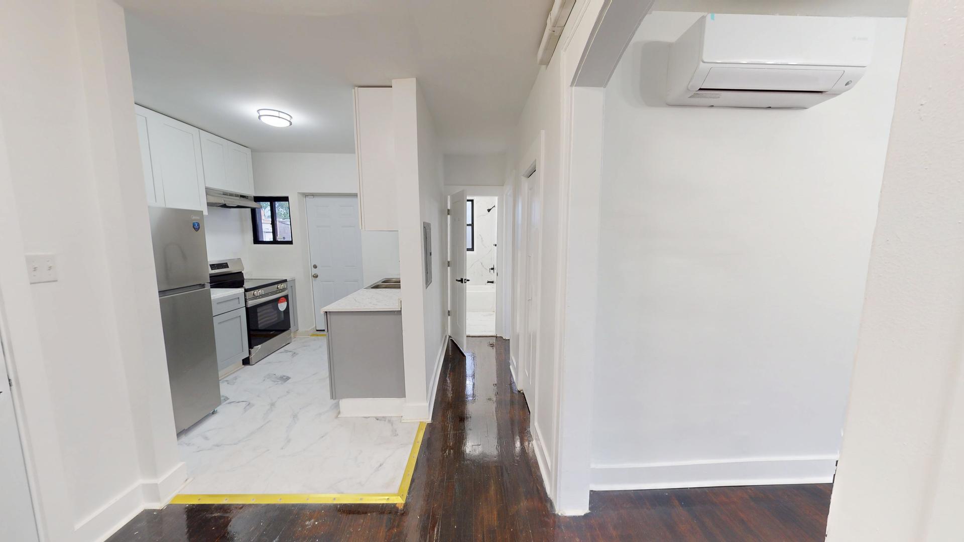 2401 East 75th Street, Unit 3 Chicago, IL 60649 - Photo 3 of 14 a view of a living room with furniture and wooden floor