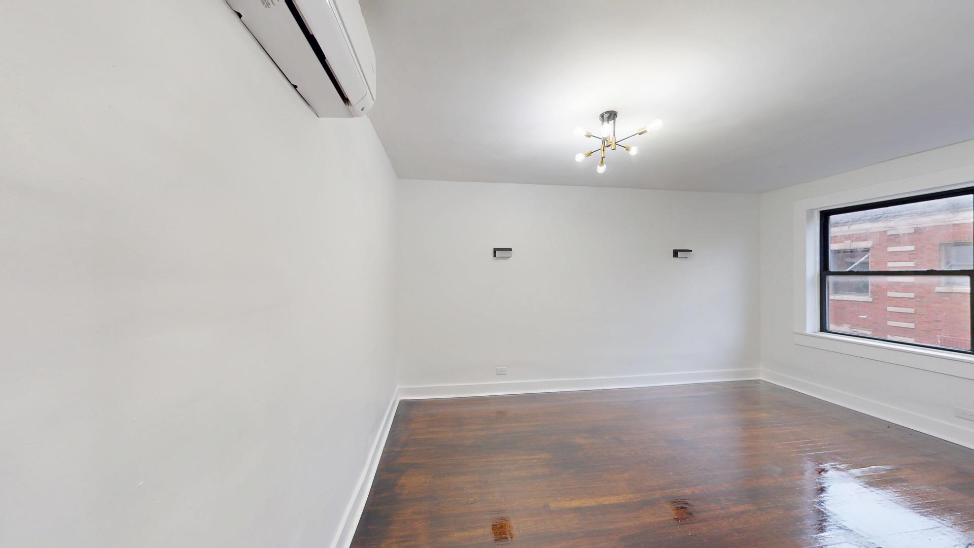 2401 East 75th Street, Unit 3 Chicago, IL 60649 - Photo 10 of 14 a view of an empty room with a window