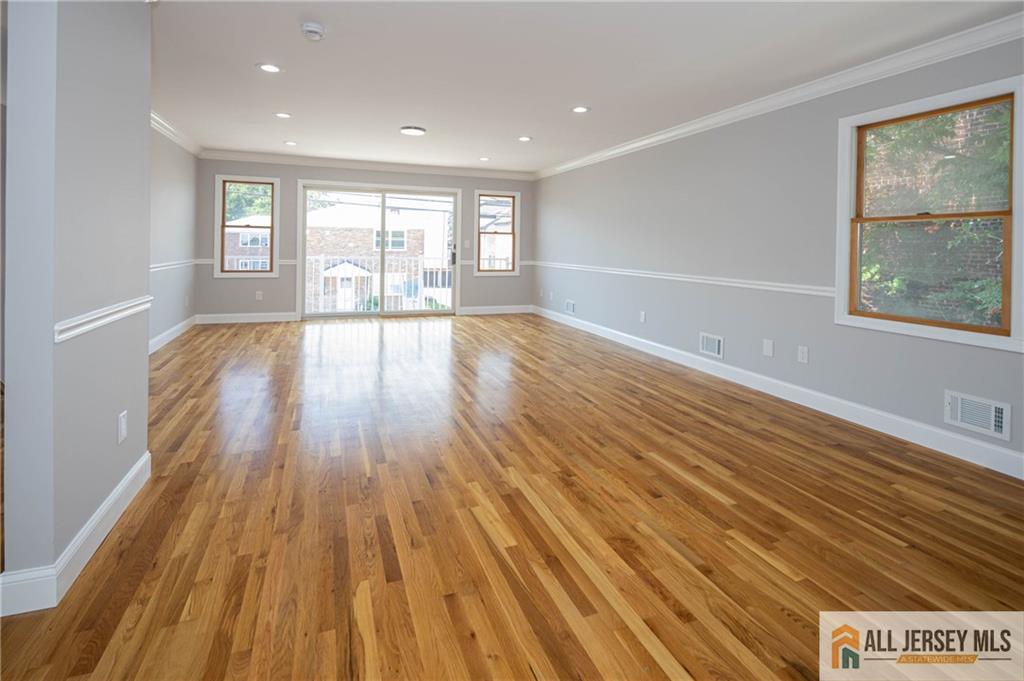 278 Rector Street Perth Amboy, NJ 08861 - Photo 16 of 47 a view of an empty room with wooden floor and glass window