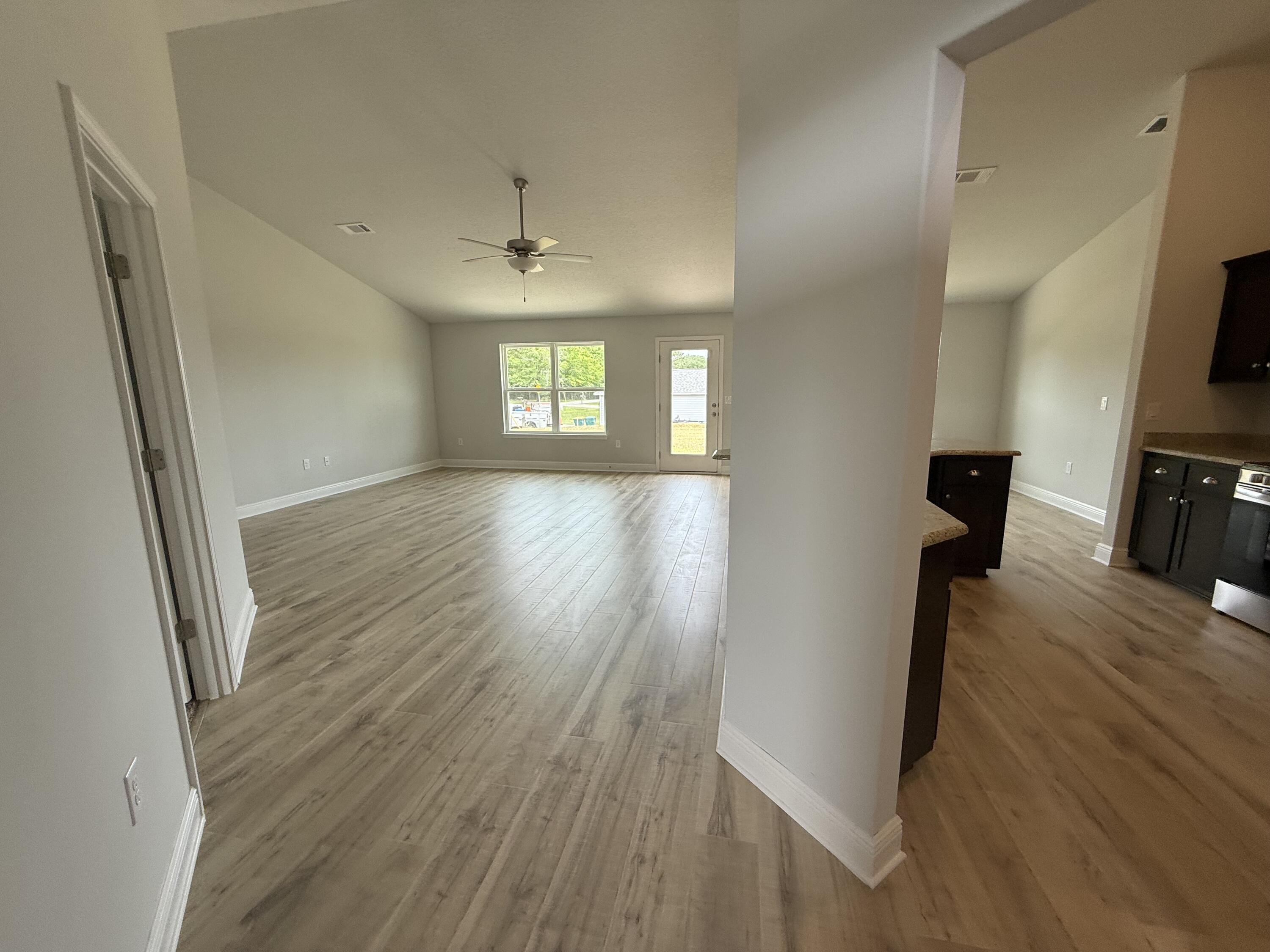 6000 Crocket Cove Crestview, FL 32539 - Photo 5 of 20 wooden floor in an empty room with a window