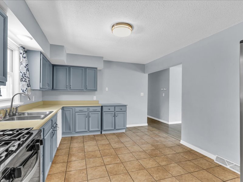 615 Breen Drive Champaign, IL 61820 - Photo 11 of 29 a large kitchen with a sink and cabinets