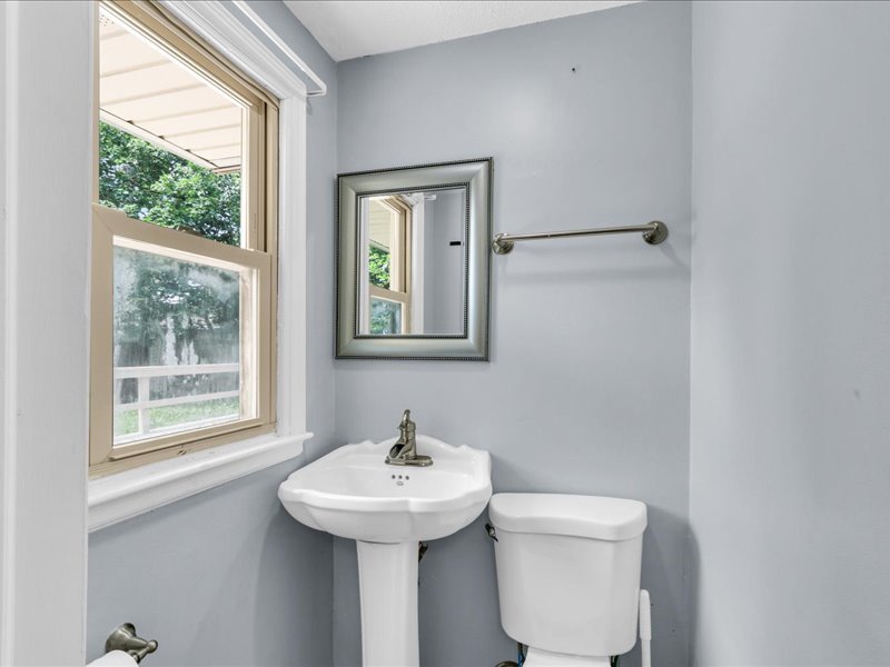 615 Breen Drive Champaign, IL 61820 - Photo 14 of 29 a bathroom with a sink toilet and a window