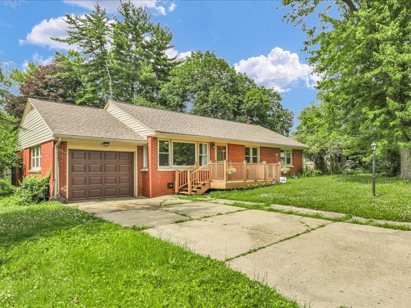 615 Breen Drive Champaign, IL 61820 - Photo 2 of 29 a front view of a house with a garden and trees