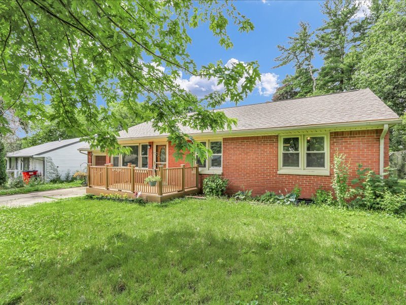 615 Breen Drive Champaign, IL 61820 - Photo 3 of 29 a front view of a house with a garden and trees