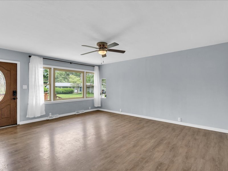 615 Breen Drive Champaign, IL 61820 - Photo 5 of 29 a view of an empty room with a window and wooden floor