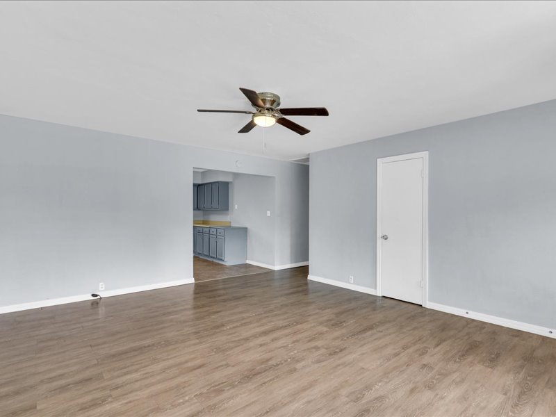 615 Breen Drive Champaign, IL 61820 - Photo 7 of 29 a view of an empty room with wooden floor and a ceiling fan