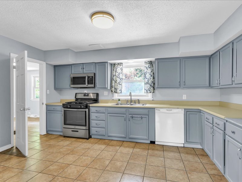 615 Breen Drive Champaign, IL 61820 - Photo 10 of 29 a large kitchen with cabinets and steel stainless steel appliances