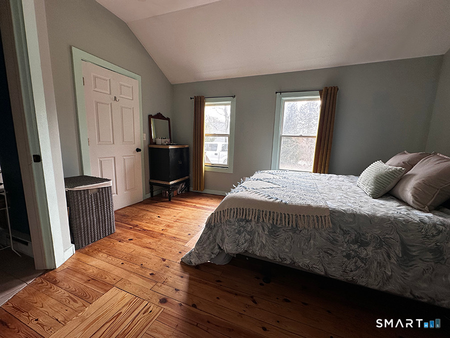79 Wesley Avenue Westbrook, CT 06498 - Photo 16 of 33 a bedroom with a bed and a large mirror on the dresser