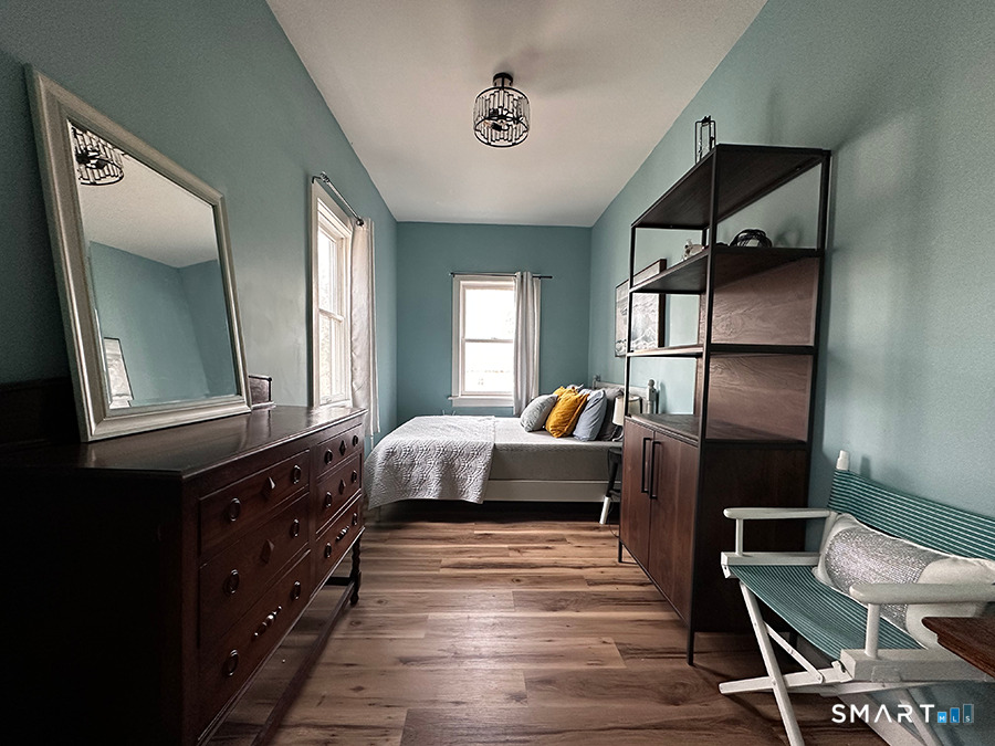 79 Wesley Avenue Westbrook, CT 06498 - Photo 23 of 33 a bedroom with a bed and a mirror