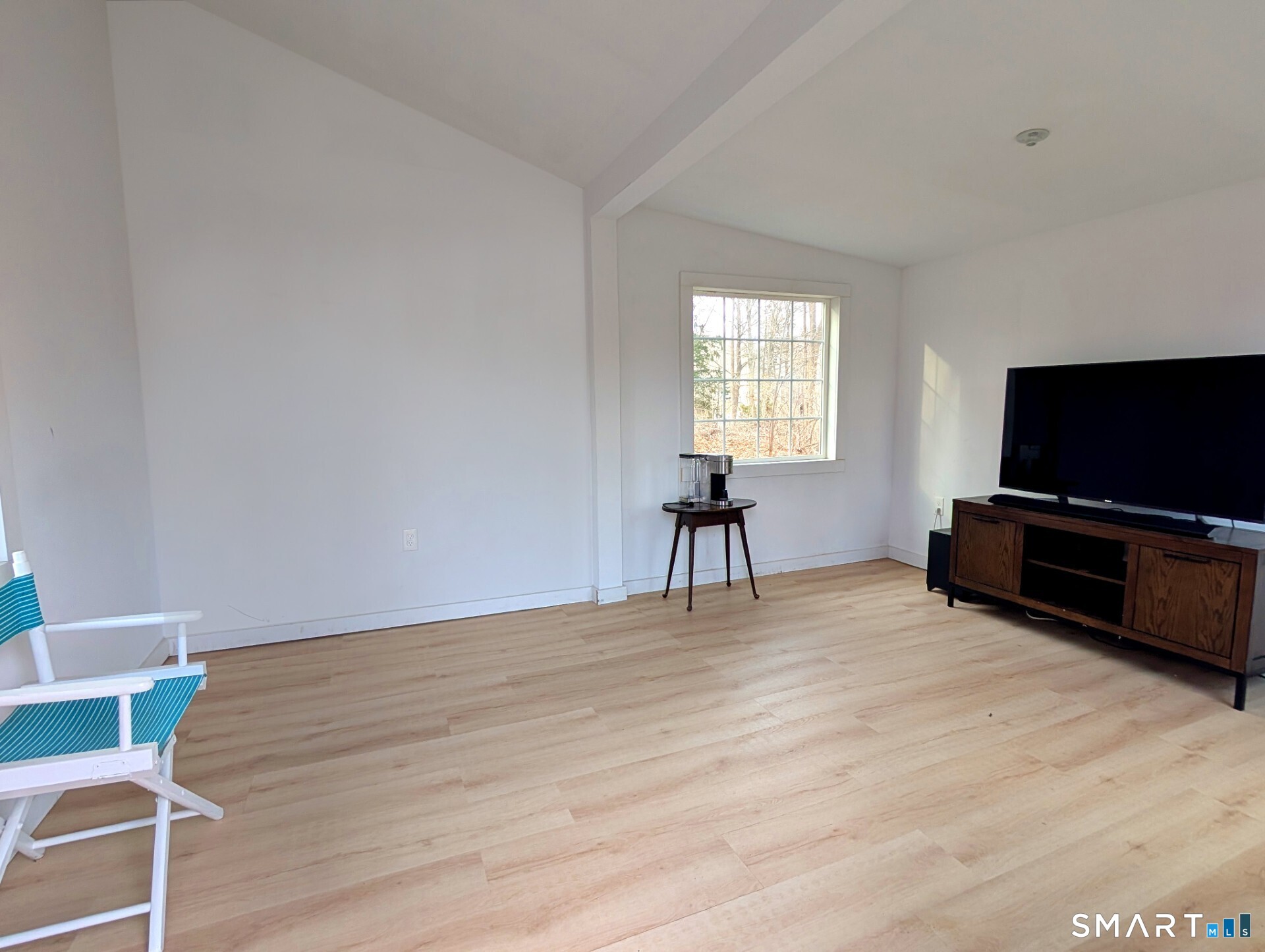 79 Wesley Avenue Westbrook, CT 06498 - Photo 31 of 33 a living room with furniture and a flat screen tv