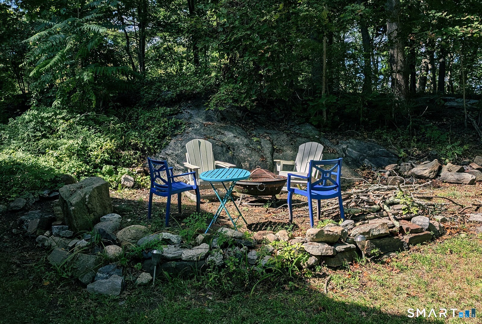 79 Wesley Avenue Westbrook, CT 06498 - Photo 4 of 33 a backyard of a house with table and chairs
