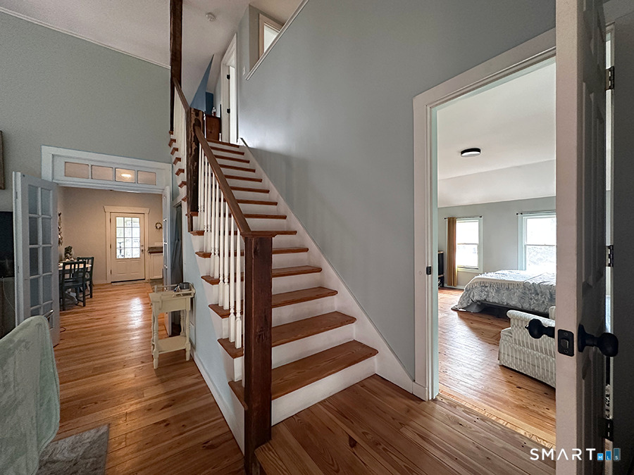 79 Wesley Avenue Westbrook, CT 06498 - Photo 10 of 33 a view of a hallway with wooden floor and staircase