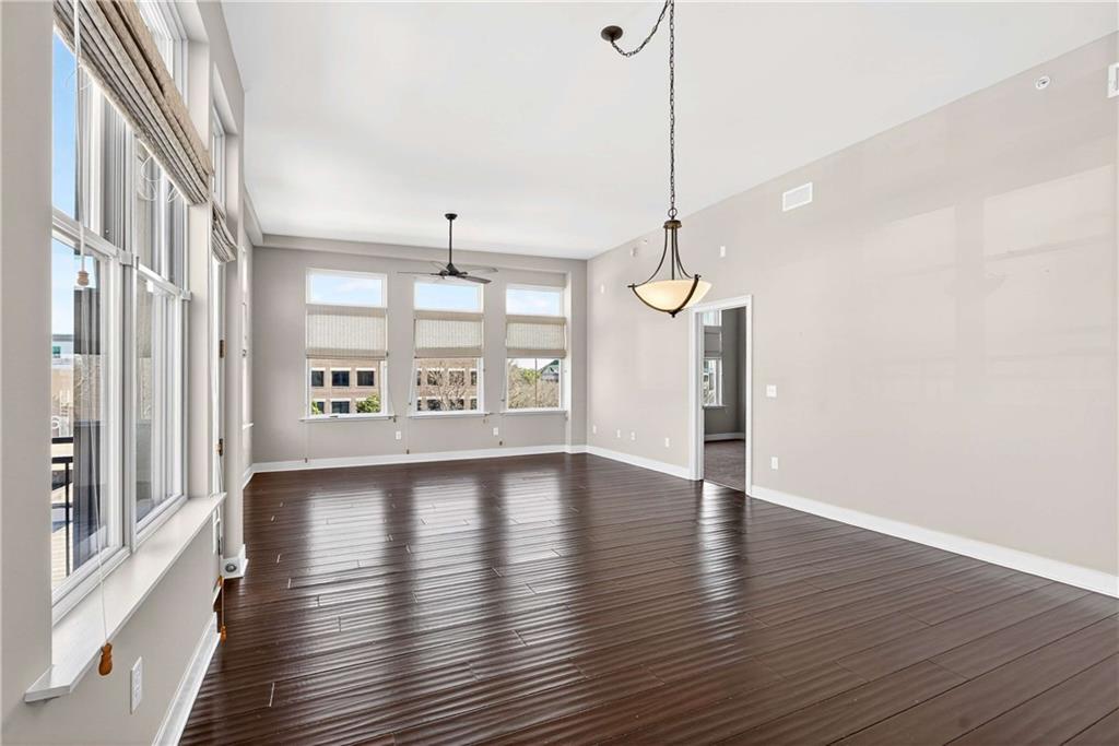 201 West Ponce De Leon Avenue, Unit 702 Decatur, GA 30030 - Photo 9 of 41 a view of an empty room with wooden floor and a window