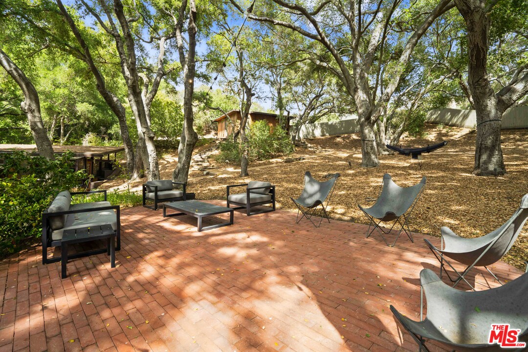 481 Cold Canyon Road Calabasas, CA 91302 - Photo 19 of 44 a view of a backyard with sitting area