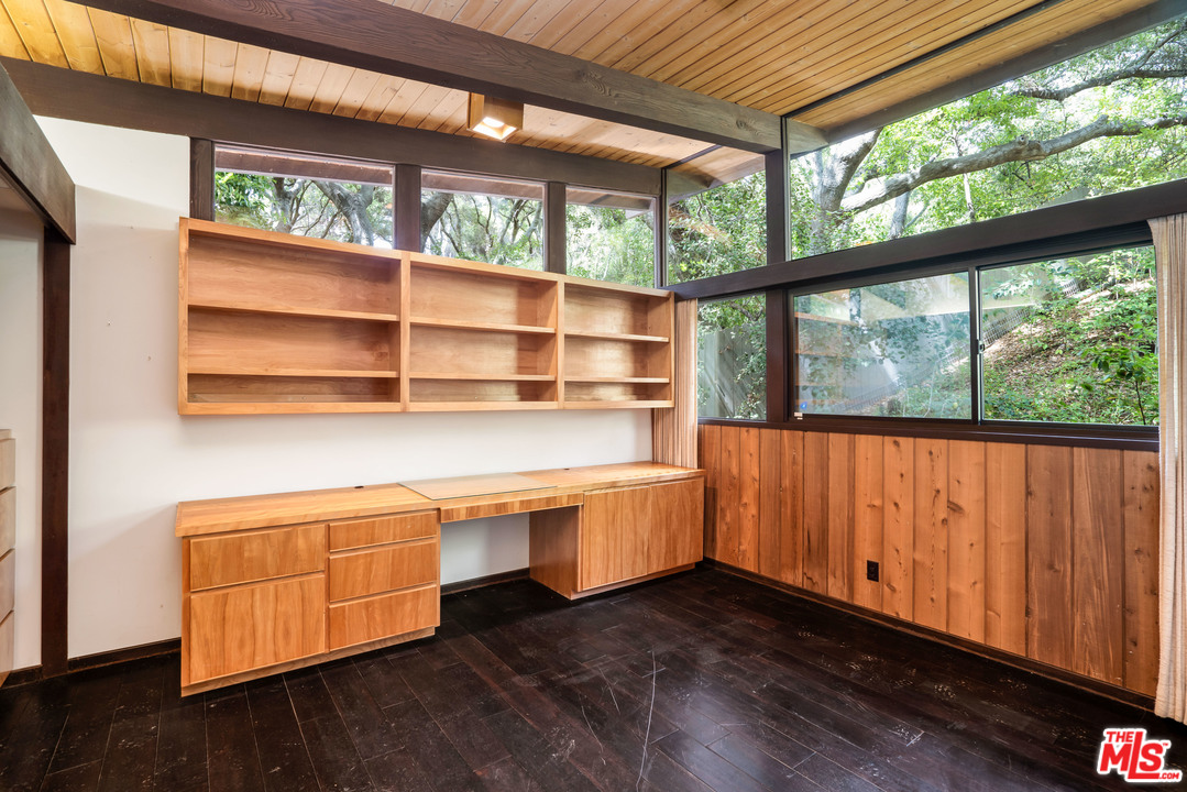 481 Cold Canyon Road Calabasas, CA 91302 - Photo 21 of 44 a room with wooden floor and furniture