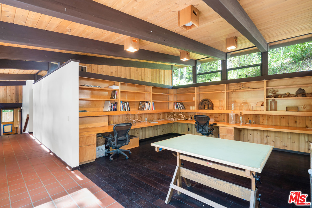 481 Cold Canyon Road Calabasas, CA 91302 - Photo 24 of 44 a room with gym equipment and large windows