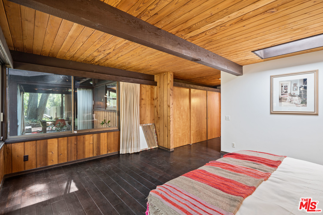481 Cold Canyon Road Calabasas, CA 91302 - Photo 25 of 44 a bedroom with natural light and wooden floor