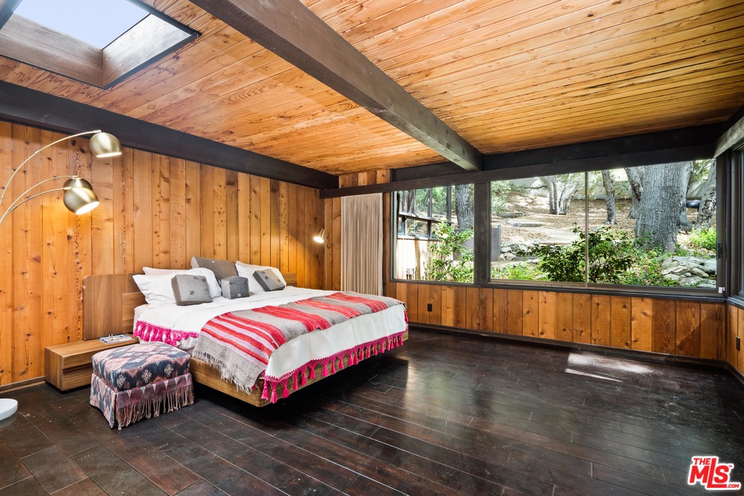 481 Cold Canyon Road Calabasas, CA 91302 - Photo 26 of 44 a bedroom with a bed and a large window
