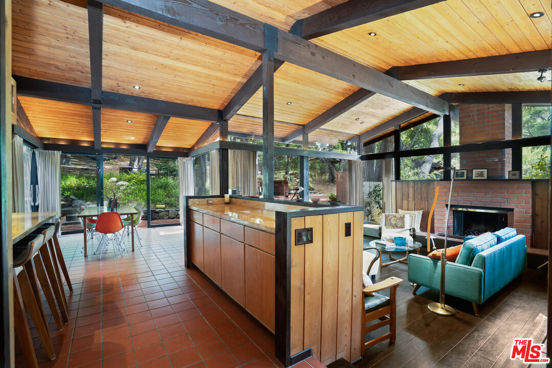 481 Cold Canyon Road Calabasas, CA 91302 - Photo 29 of 44 a view of living room kitchen with furniture and fireplace