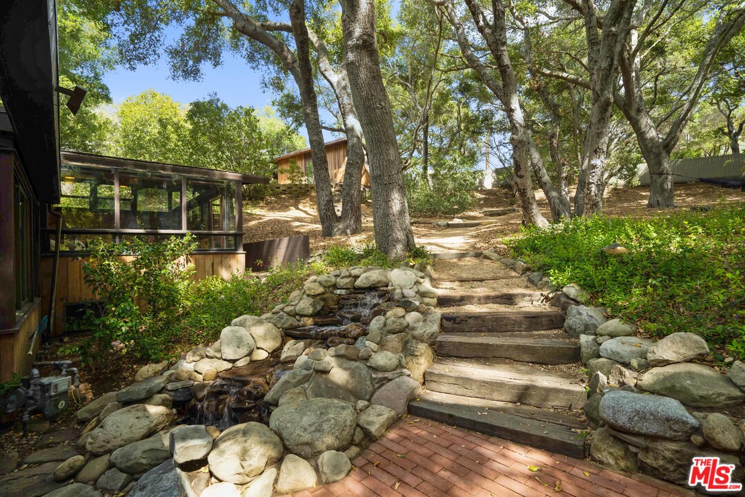 481 Cold Canyon Road Calabasas, CA 91302 - Photo 31 of 44 a view of a garden with an outdoor space